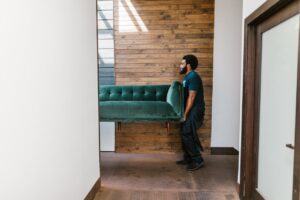 A man carrying a piece of furniture.