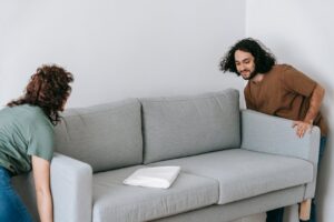 Couple moving sofa