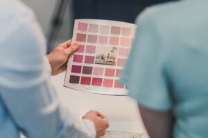 Two people looking at a paint color brochure