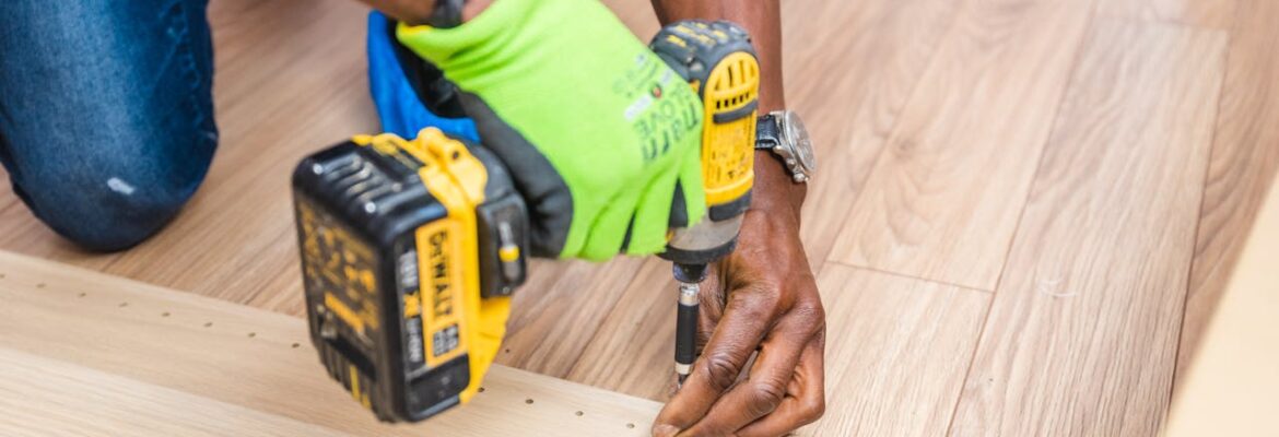 Man using DeWalt cordless hand drill on wood